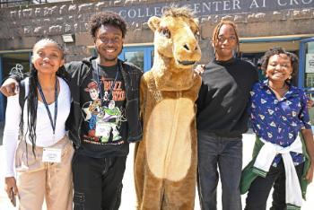 Students posing with camel mascot