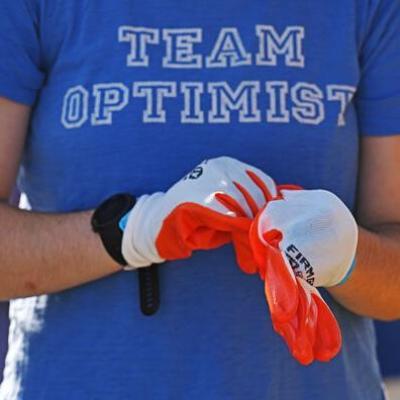 Student putting on gardening gloves