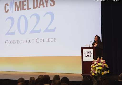 Samirah stands behind a podium in front of a crowd