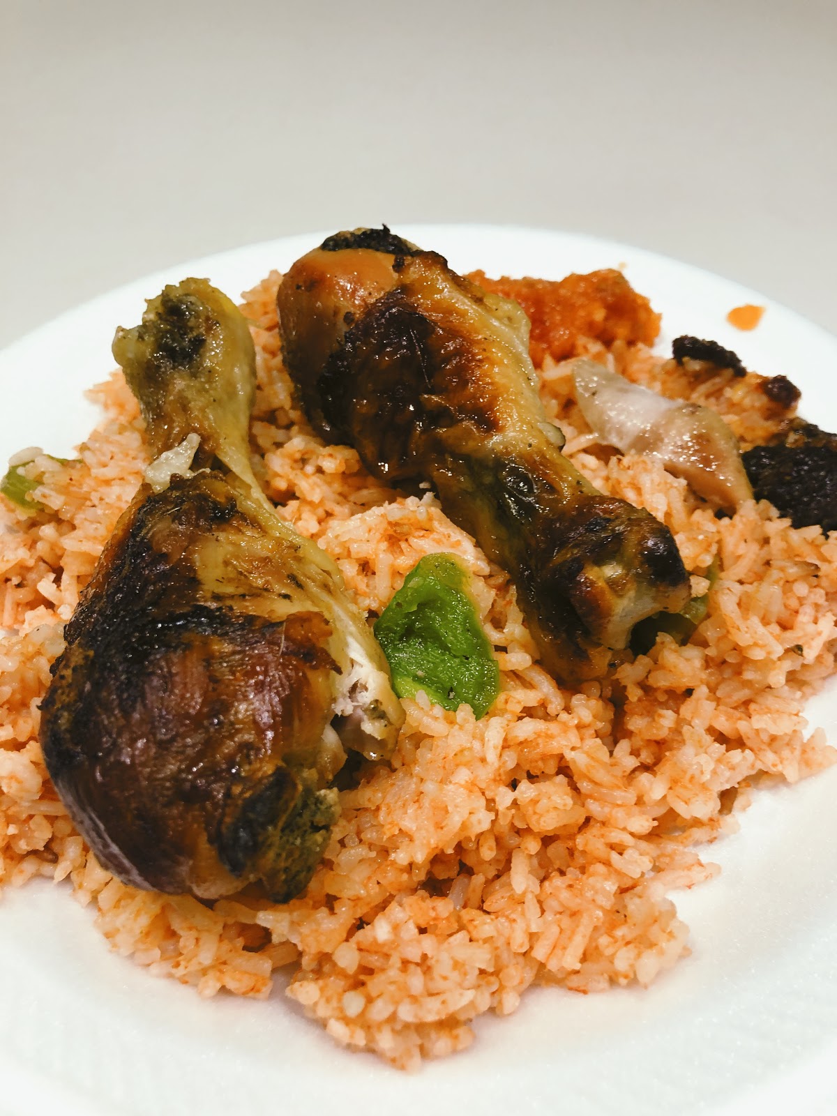 A plate of honey roasted chicken and joffof rice