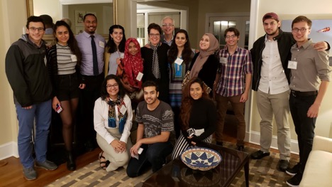 Students assemble for a photo with President Bergeron in the president's living room