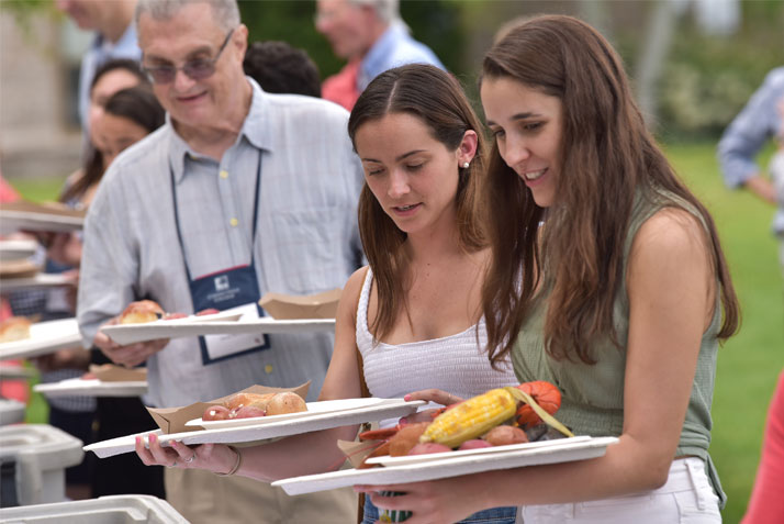 Alumni enjoying the traditional New England-style clambake on a perfect Friday evening