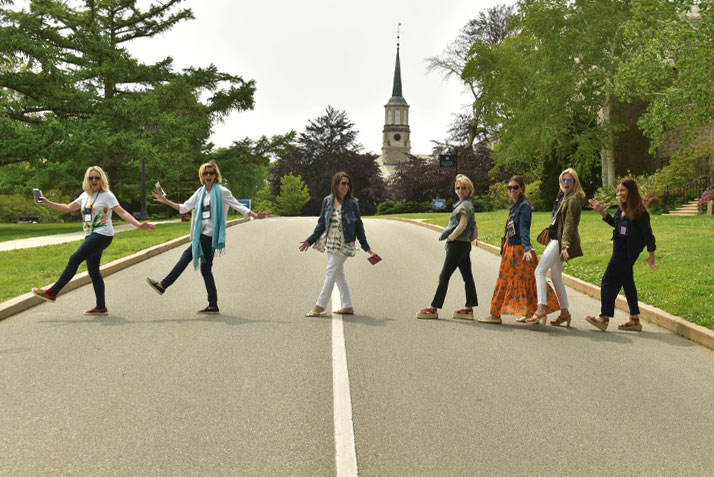 Alumni walking in front of Harkness Chapel tower