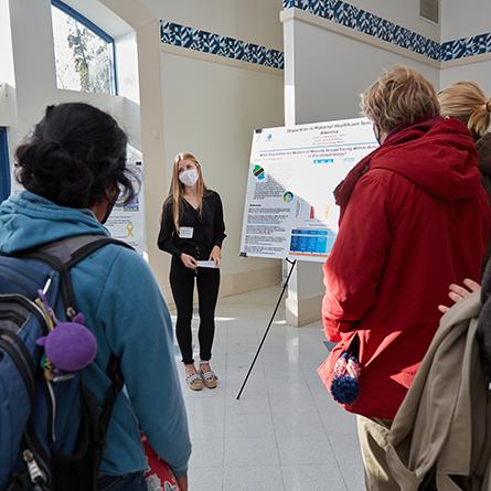 A student presents a poster at the ACS poster session. 