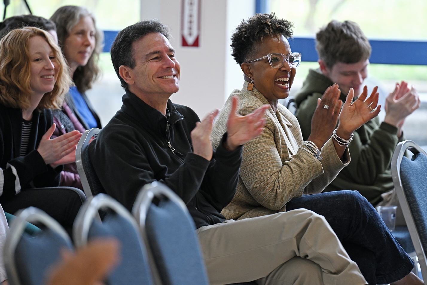 Audience members clap during Chapdelaine's remarks.