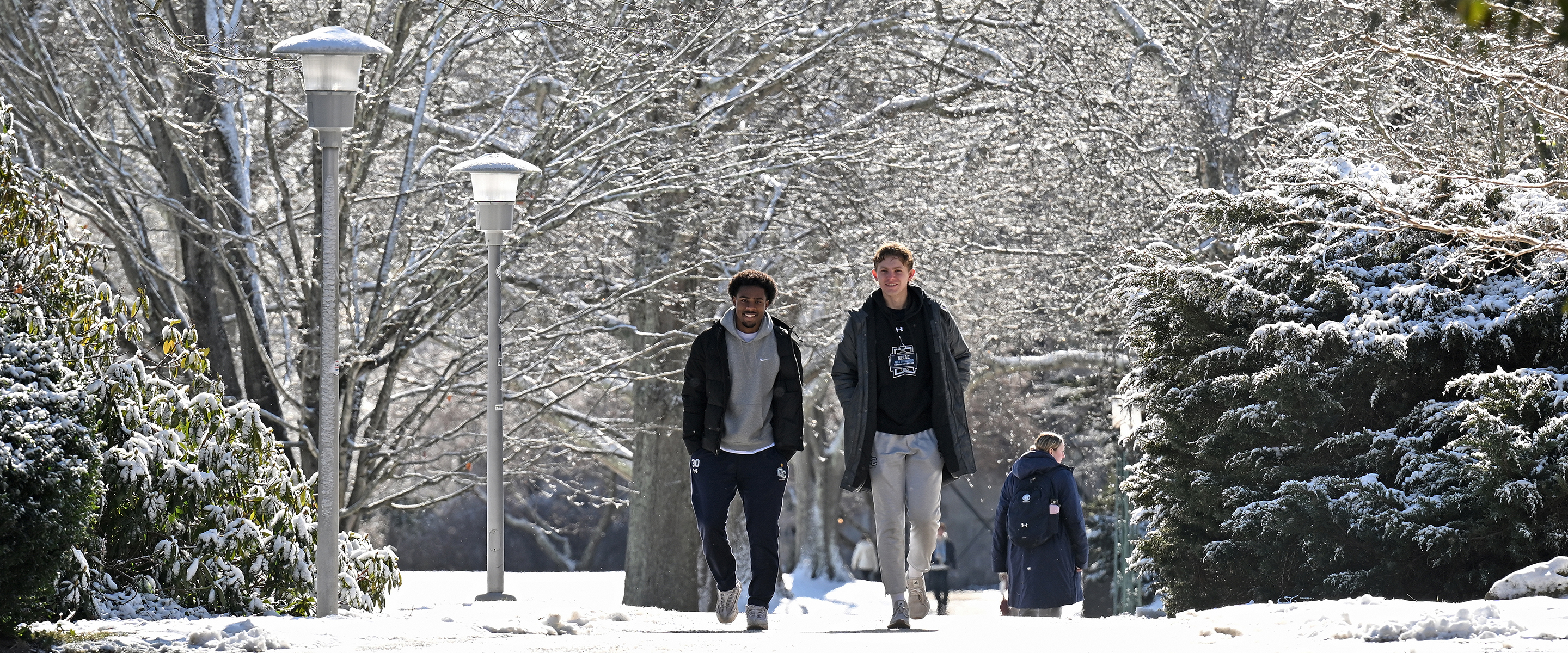 Students walk across a snow-blanketed campus.