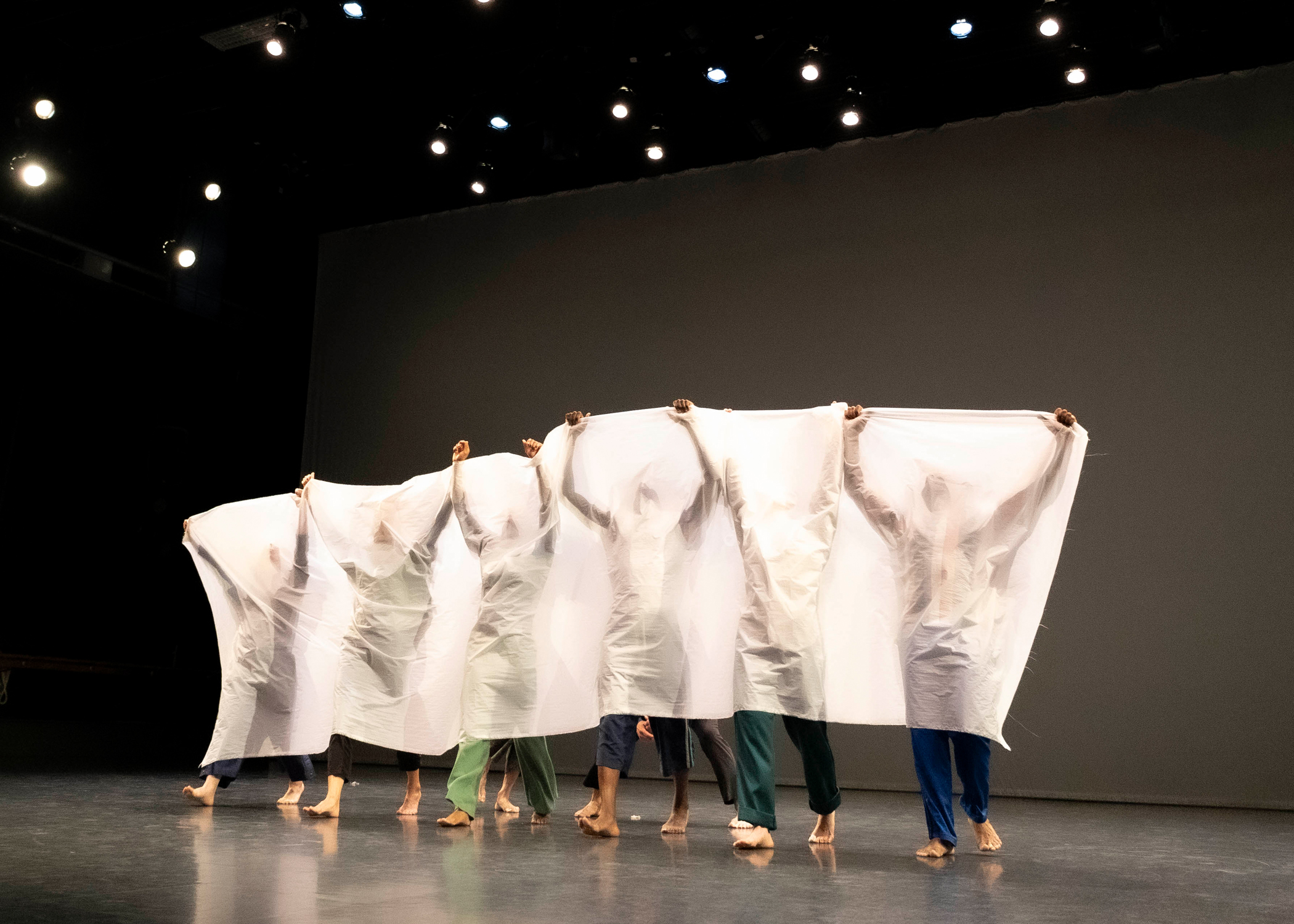 dancers covered by a white sheet